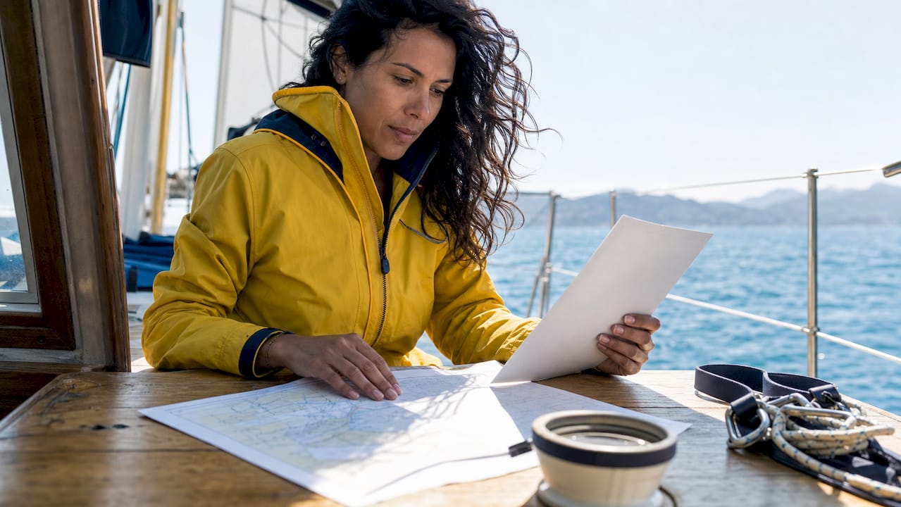 Solo sailor reviewing safety plan on yacht