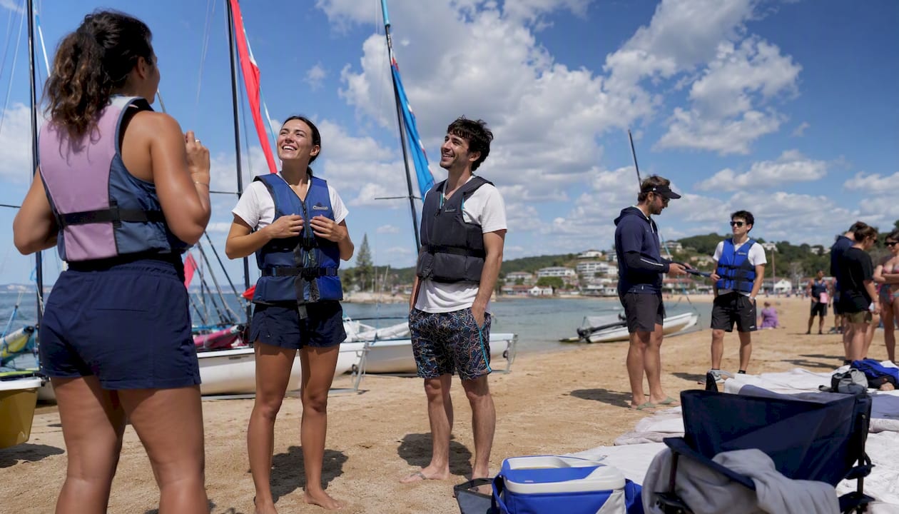 Diverse group preparing for social sailing event