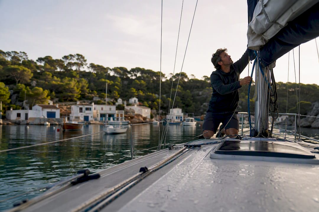 Sailboat mooring in Mediterranean cove at sunset