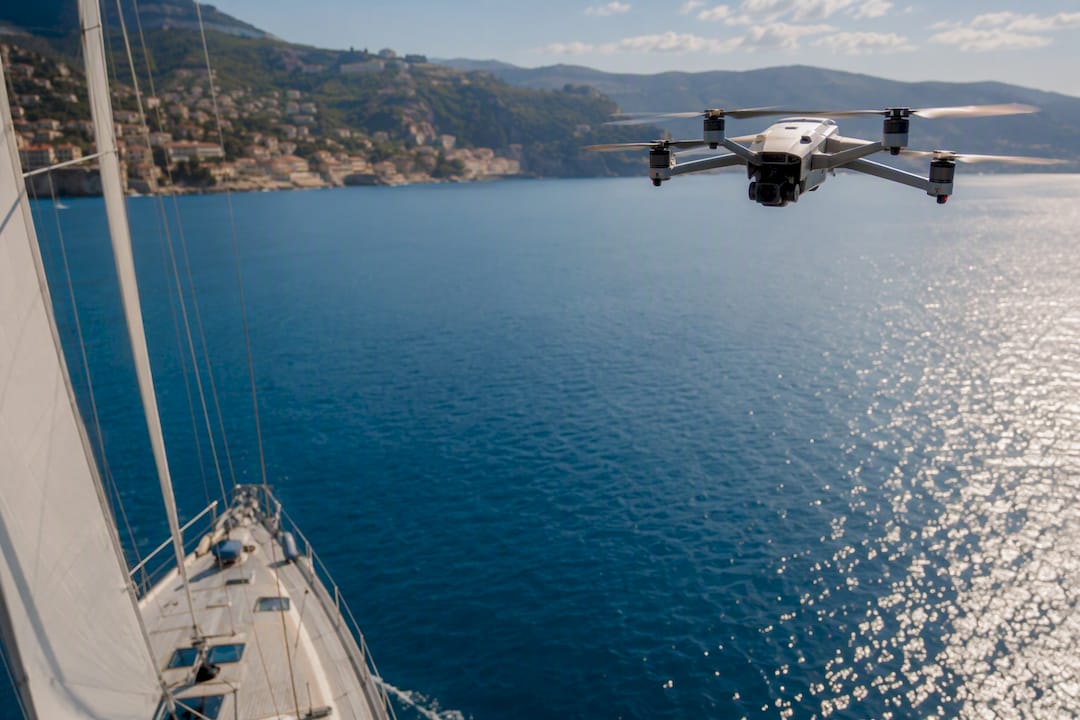 Drone flying above yacht on Mediterranean sea