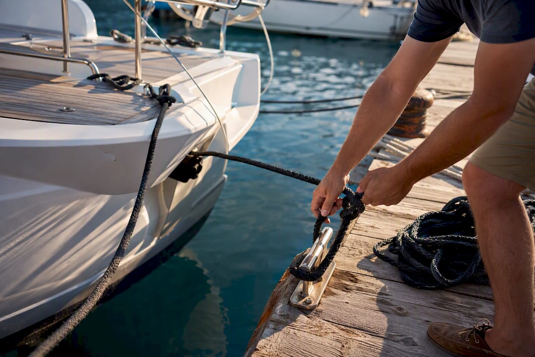 Skipper hands knotting mooring lines at Greek marina