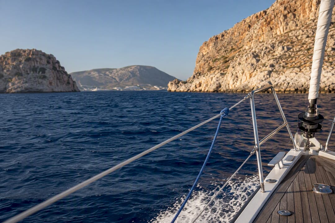Sailboat passing between Dodecanese islands