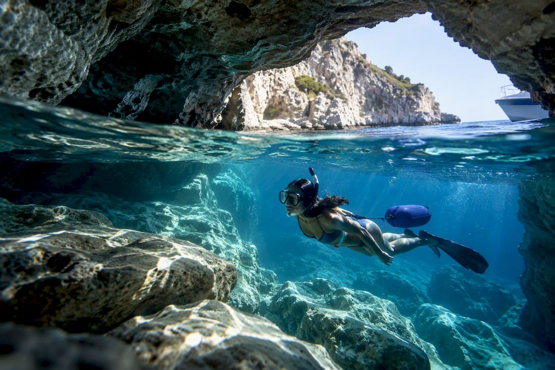 Snorkeler exploring a Greek sea cave