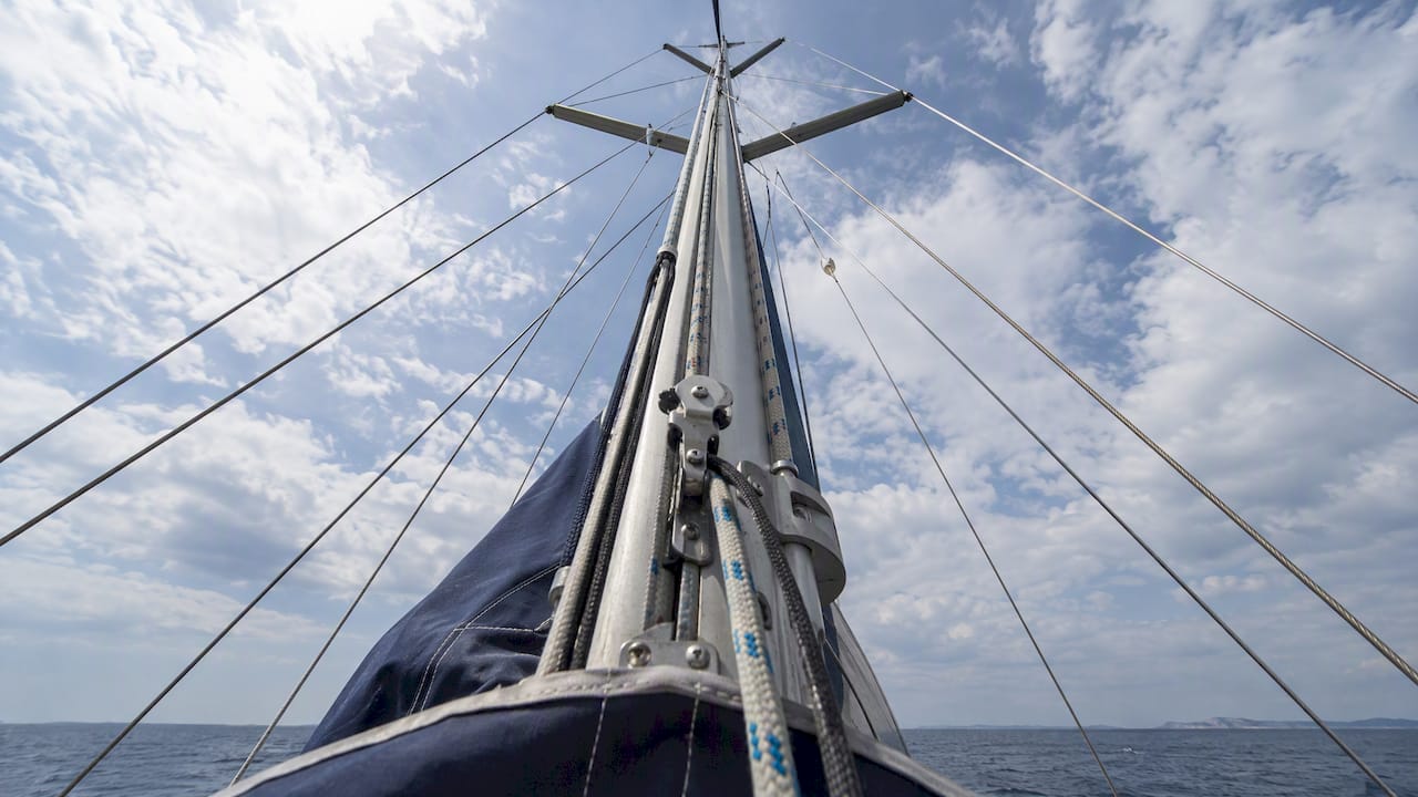 Sailboat rigging lines crossing open sky