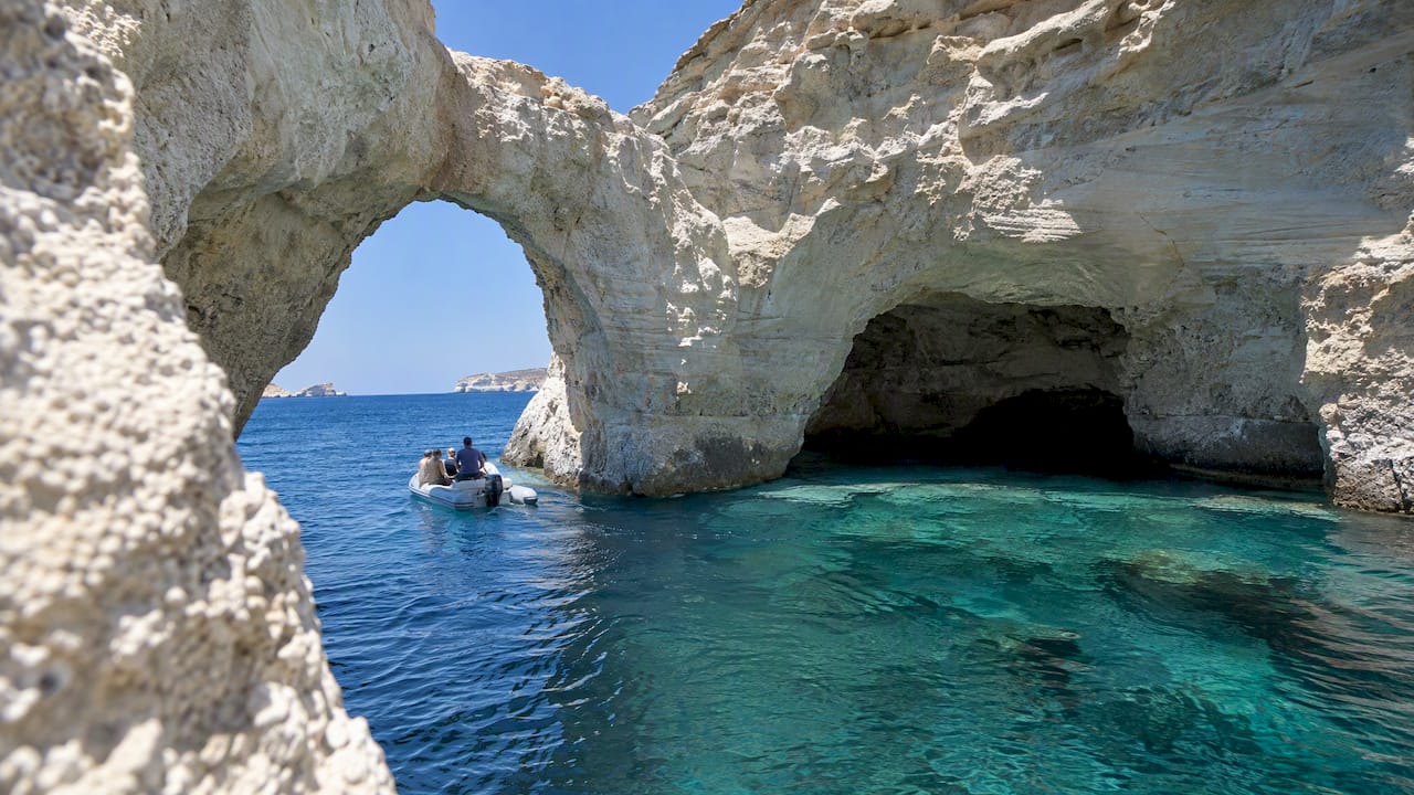 Tender passing beneath a Kleftiko sea arch